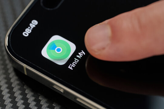 Touching Find My app icon with finger