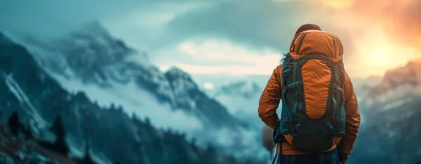Foto op Canvas a man with a backpack looking over a snow capped mountains © ryker
