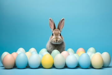 Fototapeta na wymiar easter rabbits, easter eggs and basket on blue background