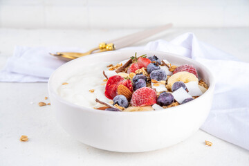 Breakfast yogurt granola bowl with fruit and berry