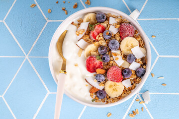 Breakfast yogurt granola bowl with fruit and berry