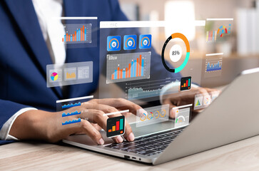 Analyst utilizing technology and dashboard with charts data science and Big Data technology for...
