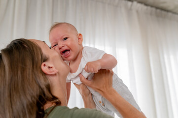 Young new mom holding a cute baby in her arms