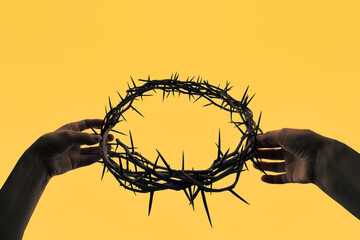 Hands holding crown of thorns - 729337628