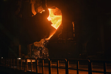 Pouring of hot liquid metal in a steel plant - 729337883