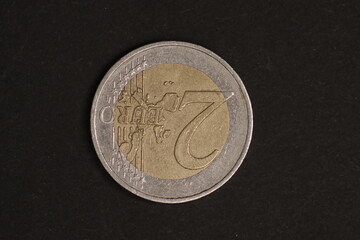 Used euro coin of older age on dark background. Big closeup of coin. Money, Cash, Time, Finance...