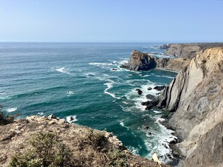 Rocky ocean coast, ocean bay, blue sky