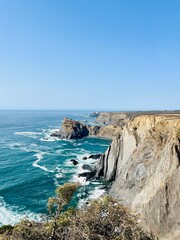 Rocky ocean coast, ocean bay, blue sky
