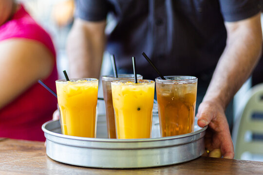 Drinks being served on tray at pub orange juice and ginger ale