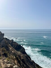 Fototapeta na wymiar Rocky ocean coast, ocean bay, blue sky