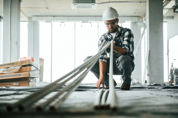 Construction worker in uniform in empty unfinished room