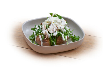Bowl with hot patatoes, salad and tartufata on white and wood