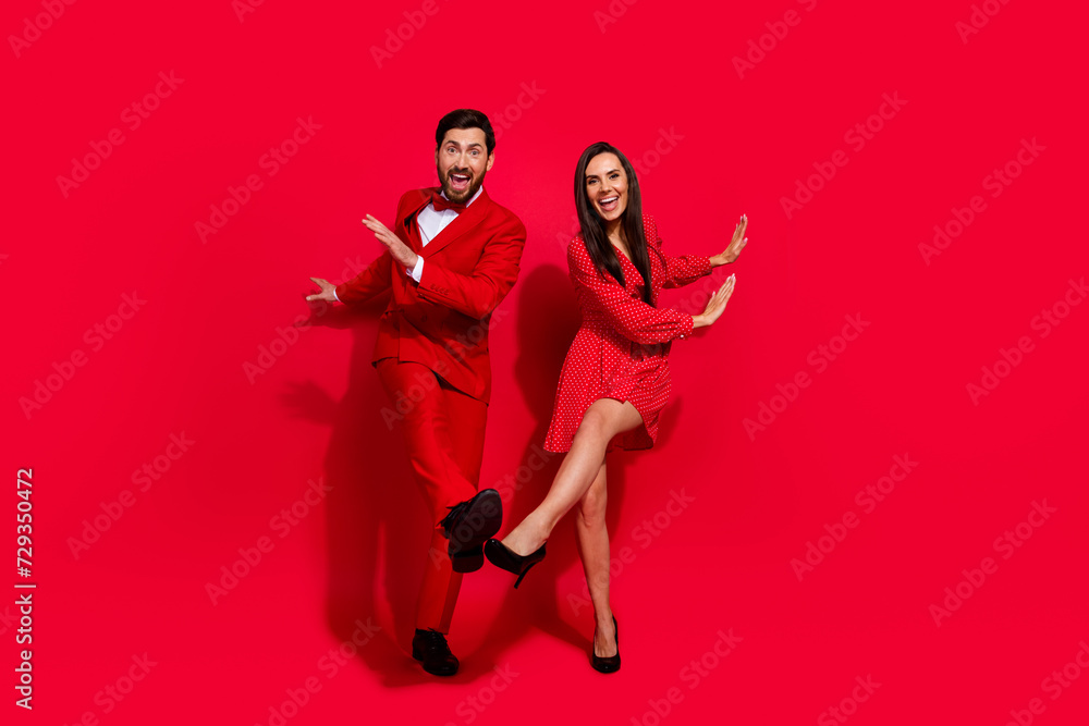 Poster full size portrait of positive crazy partners have good mood xmas eve dancing isolated on vivid red 