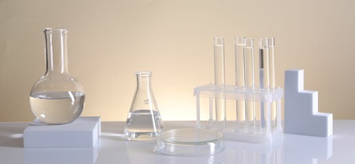 Laboratory analysis. Different glassware on table against beige background