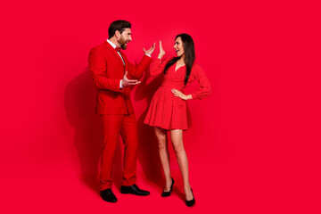 Full length portrait of two outraged negative partners yell fight each other empty space isolated on red color background