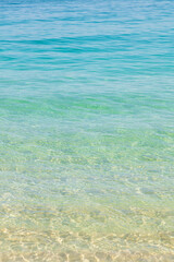 Fototapeta na wymiar Close-up of the crystal clear waters and gradient of the sea at Praia do Dentist, one of the most beautiful beaches in Brazil and Rio de Janeiro.
