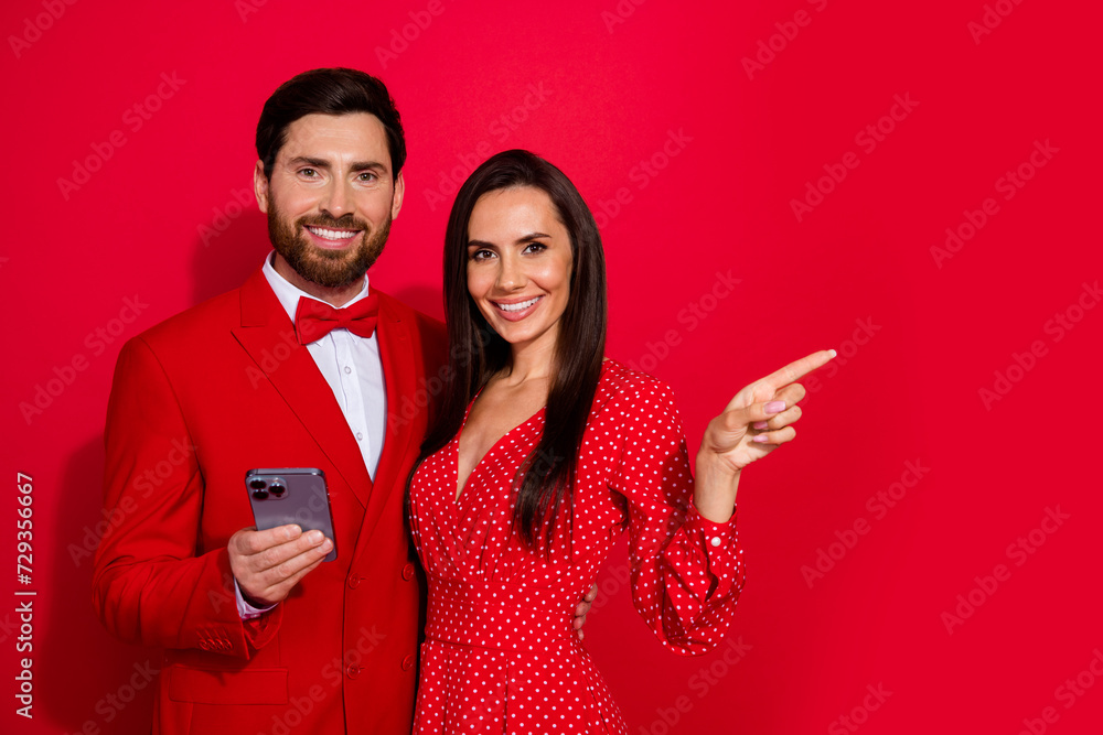 Poster Portrait of two classy elegant partners hug hold smart phone indicate finger empty space isolated on red color background