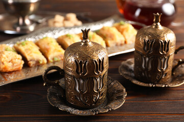 Traditional Turkish tea and fresh baklava served in vintage tea set on wooden table