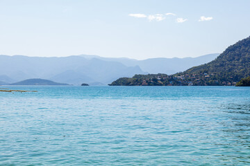 Landscape of Dentista beach during a beautiful sunny morning. One of the most beautiful beaches in Brazil and Rio de Janeiro, located on a small island with white sand and crystal clear water.