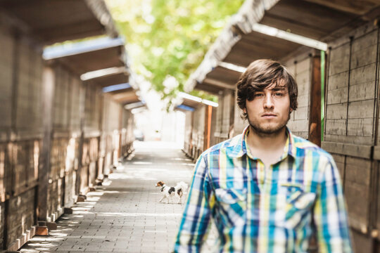 Portrait of young man in between little huts. Munich, Germany 