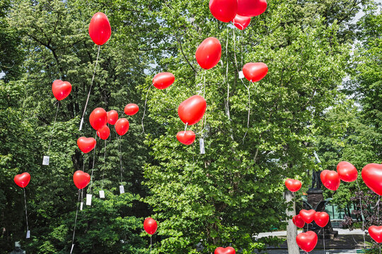  red heart balloons in the garden