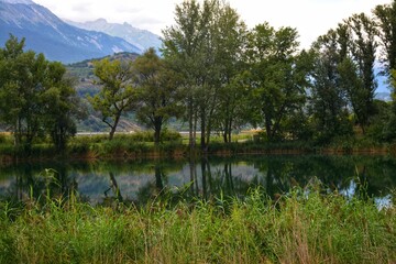 Fototapeta na wymiar Landscape with a lake and mountains n the background, South Tyrol, Italy