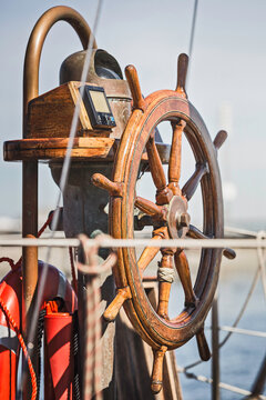 Close-Up of wooden ships steering wheel on vintage ship.