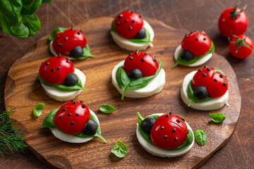 caprese ladybug tomatoes, mozzarella cheese and basil appetizers - obrazy, fototapety, plakaty
