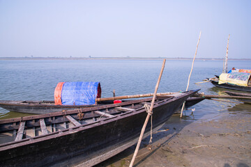 Fototapeta na wymiar landscape view of Some wooden fishing boats on the shore of the Padma river in Bangladesh