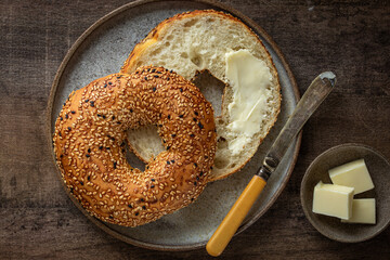 freshly baked bagel with butter - 729368047