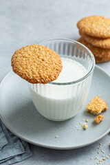 Glass of milk and sesame seeds cookies