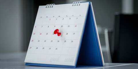 Mark on calendar white paper desk calendar with drawing-pins appointment and business meeting...