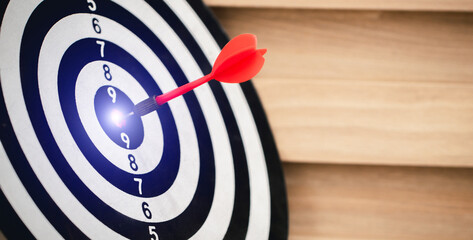 Red dart hitting on the target center dartboard, Business targeting or goal success and winner...
