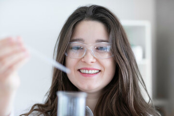 scientist young woman working in a labor with lab glasses