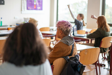 group of teenage student participating in class activities 