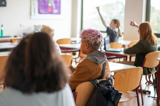group of teenage student participating in class activities 