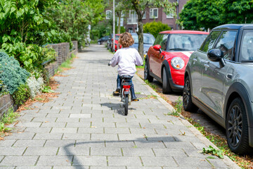 Young boy first time riding a bike .