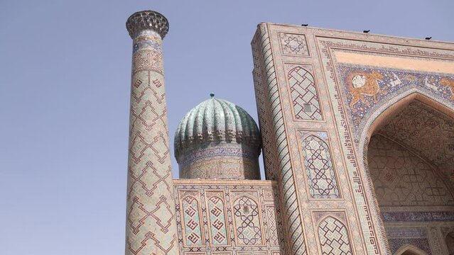ornate fascade of madrassa and mosques with detailed tiling in Samarkand, Uzbekistan along the historic Silk Road