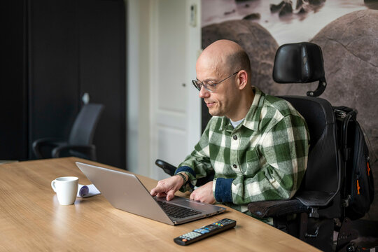 Disabled businessman working on his computer. 