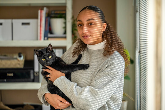 Portrait Of A Beautiful Woman Holding Her Cat 