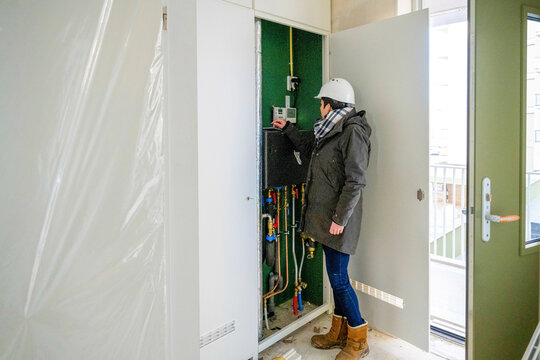 Female Construction manager inspecting electrical installation