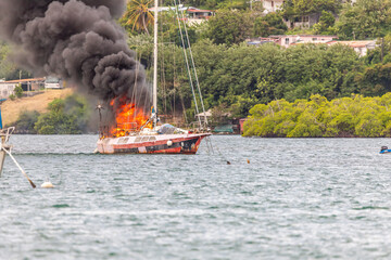 Sailboat on fire in Le Marin, Martinique, France