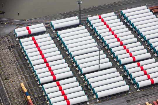 Aerial image of wind turbine parts stacked in container port being ready to ship. Bremerhaven, Germany