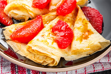 Crepes grapefruit citrus pancakes tasty fresh healthy eating cooking appetizer meal food snack on the table copy space food