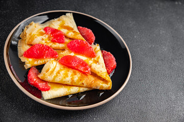 Crepes grapefruit citrus pancakes tasty fresh healthy eating cooking appetizer meal food snack on the table copy space food