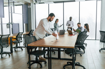 Team of office workers are together indoors