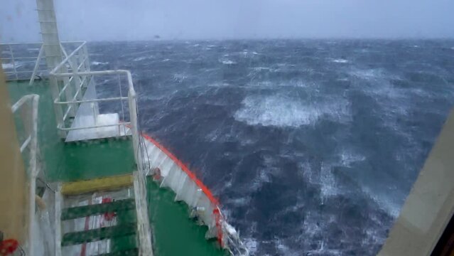 Storm in ocean. Navigation bridge of the ship is covered by a wave