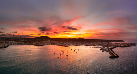 Spectacular aerial panoramic landscape image of the evening sunset sky at golden hour over the town of Corralejo, Fuerteventura, Canary Islands, Spain