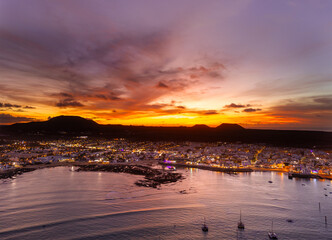 Spectacular aerial panoramic landscape image of the evening sunset sky at golden hour over the town of Corralejo, Fuerteventura, Canary Islands, Spain