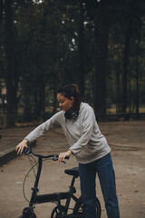 Obraz premium Happy Asian young woman walk and ride bicycle in park, street city her smiling using bike of transportation, ECO friendly, People lifestyle concept.